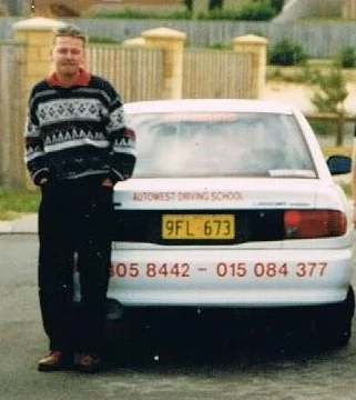Darry Zarb Cousin standing beside an early driving school car Darry Zarb Cousin standing beside an early driving school car