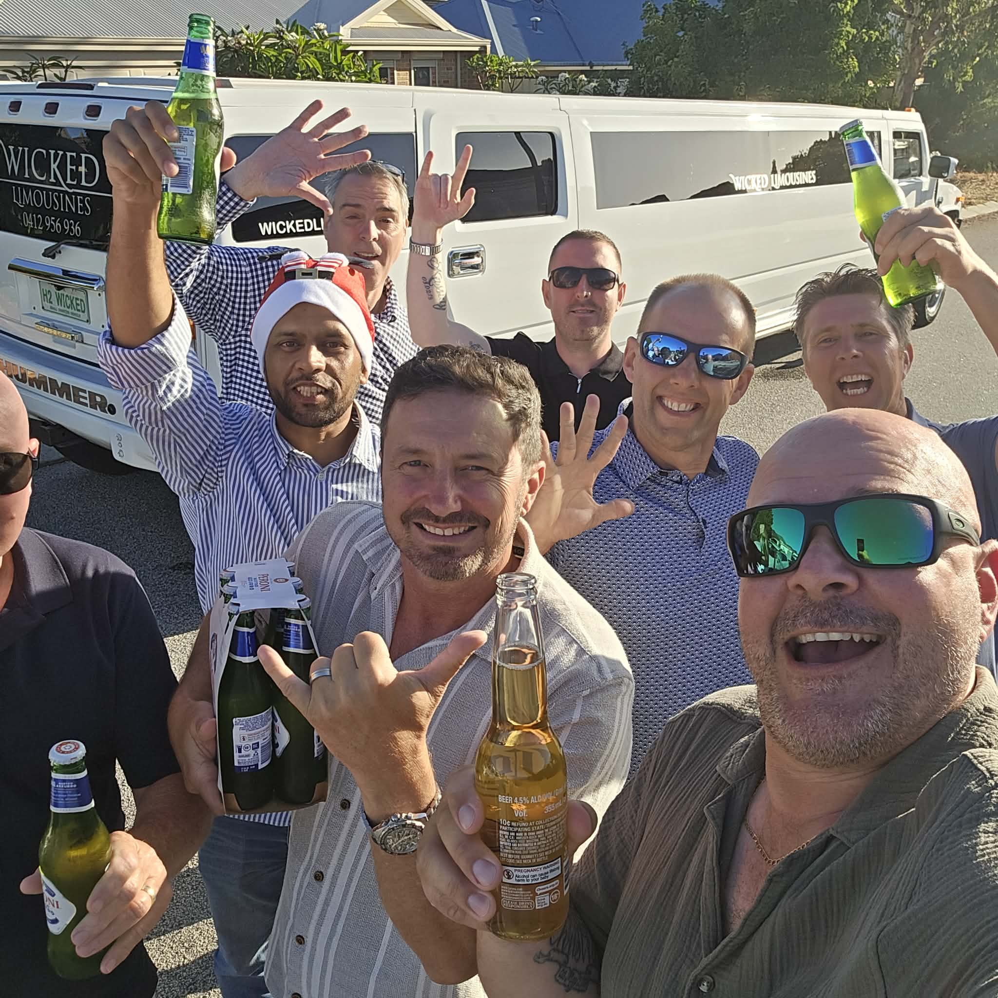 Driving West Christmas team celebration 2025 Driving West team sharing a cheerful group selfie beside their Christmas limousine